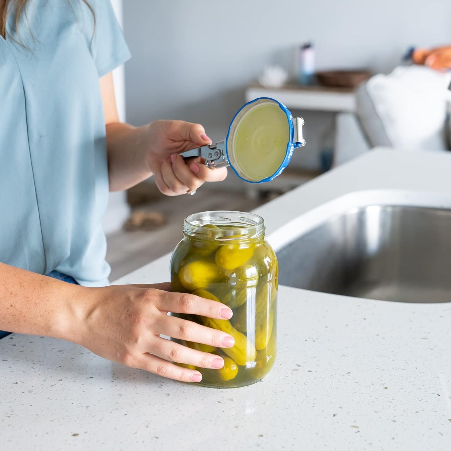 Hands with Keychain Bottle Cap Opener. Jar Gripper Tight Lid Opener and Bottle Opener Kitchen Gadgets